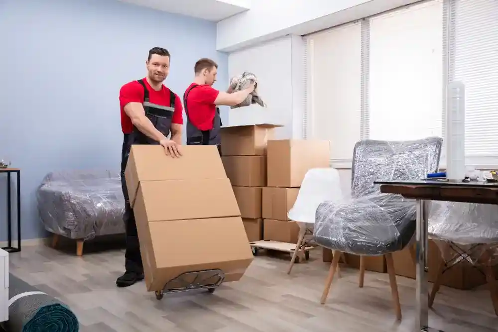 Experienced commercial moving team packing and securing office equipment.