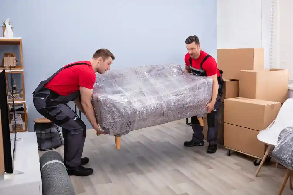 Experienced movers skillfully assembling furniture in a new home.